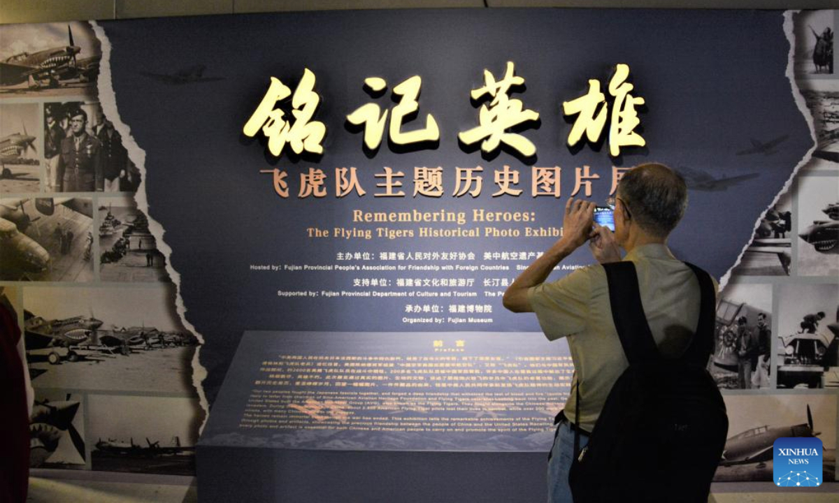 A man takes photos while visiting Remembering Heroes: The Flying Tigers Historical Photo Exhibition at Fujian Museum in Fuzhou, southeast China's Fujian Province, June 24, 2025. The exhibition opened here on Tuesday, showcasing hundreds of valuable photos contributed by veterans of the Flying Tigers, as well as other items of historic significance. (Xinhua/Li Haoze)