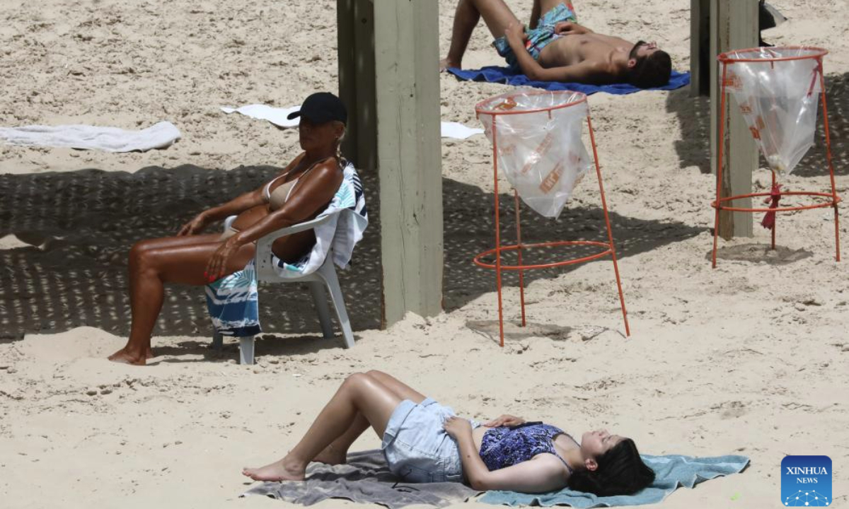 People enjoy themselves at a beach after a ceasefire between Iran and Israel took effect in Tel Aviv, central Israel, on June 24, 2025. (Gideon Markowicz/JINI via Xinhua)
