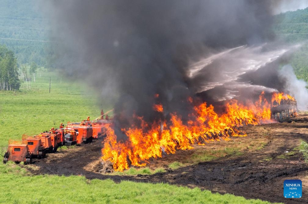 Rescuers put out a fire during a drill in the Dahinggan Mountains, northeast China's Heilongjiang Province, June 24, 2025. Local fire brigades conducted a fire drill in the Dahinggan Mountains on Tuesday to improve their preparedness and response mechanism. The drill featured four typical scenarios, namely emergence response, fighting primitive forest fires, fighting fuel storage tank fires, and fighting high-rise building fires. (Photo: Xinhua)