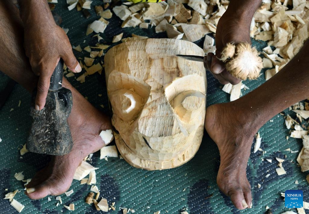A traditional Sri Lankan mask maker cuts a wooden block to create a mask in Gonapola village, Sri Lanka on June 25, 2025. The southern region of Sri Lanka, especially south of Colombo, is famous for the making and use of wooden masks, which play an important role in rituals and dances. (Photo: Xinhua)