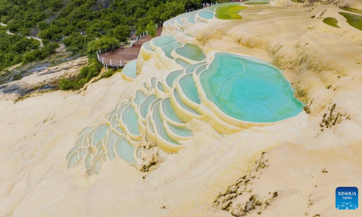 An aerial drone photo shows a view of Baishuitai in Sanba Township, Shangri-la, the Deqen Tibetan Autonomous Prefecture, southwest China's Yunnan Province, June 26, 2025. Formed by the sediments of high calcium carbonate in spring waters, Baishuitai is one of the biggest limestone terraces in China. (Xinhua/Pu Chao)