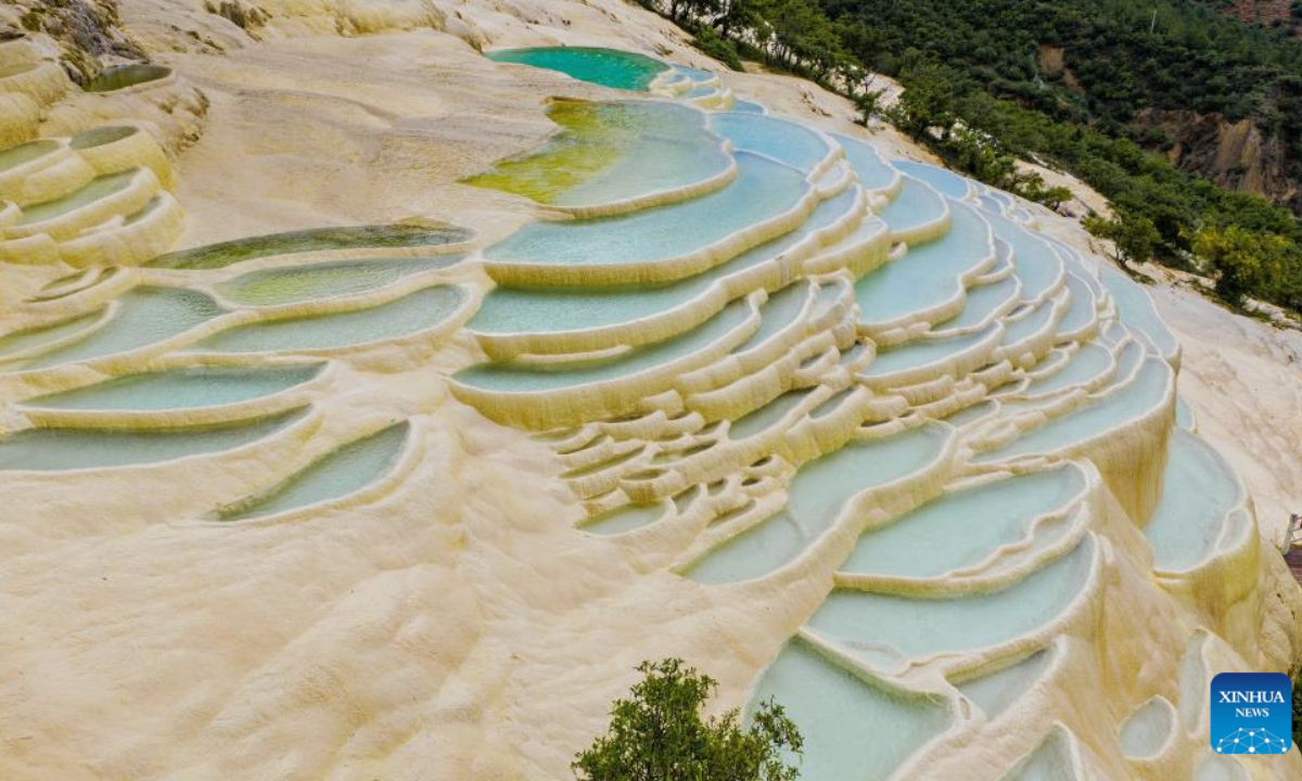 An aerial drone photo shows a view of Baishuitai in Sanba Township, Shangri-la, the Deqen Tibetan Autonomous Prefecture, southwest China's Yunnan Province, June 26, 2025. Formed by the sediments of high calcium carbonate in spring waters, Baishuitai is one of the biggest limestone terraces in China. (Xinhua/Pu Chao)