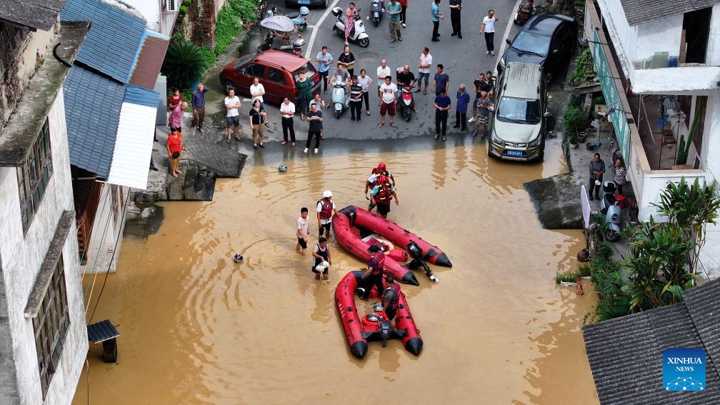 An aerial drone photo shows rescuers helping residents across the flood water in Rong'an County, south China's Guangxi Zhuang Autonomous Region, June 25, 2025. The local authorities beef up flood control and rescue efforts as days of torrential rains triggered flooding in several places in Guangxi. (Photo: Xinhua)