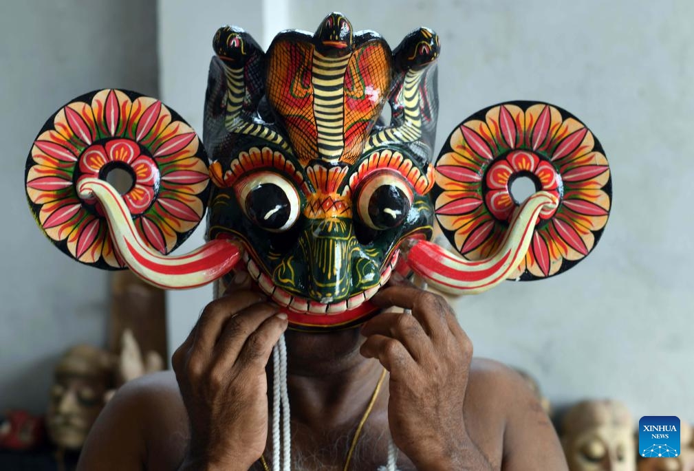 A traditional Sri Lankan mask maker shows a wooden mask in Gonapola village, Sri Lanka on June 25, 2025. The southern region of Sri Lanka, especially south of Colombo, is famous for the making and use of wooden masks, which play an important role in rituals and dances. (Photo: Xinhua)