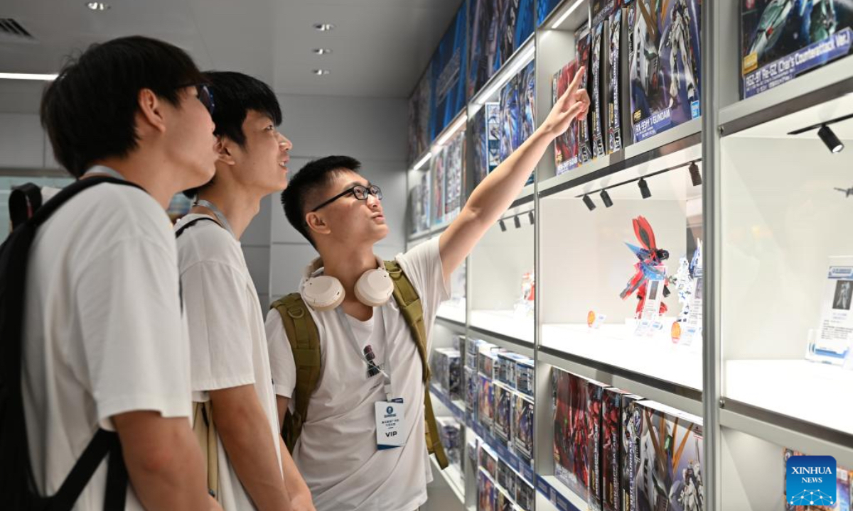 Visitors select products at a Gundam Base flagship store in Guangzhou, south China's Guangdong Province, June 26, 2025. The largest Gundam Base flagship store in the Chinese mainland officially opened Friday in the southern metropolis of Guangzhou, offering an immersive experience for Gundam model enthusiasts. (Xinhua/Huo Siying)