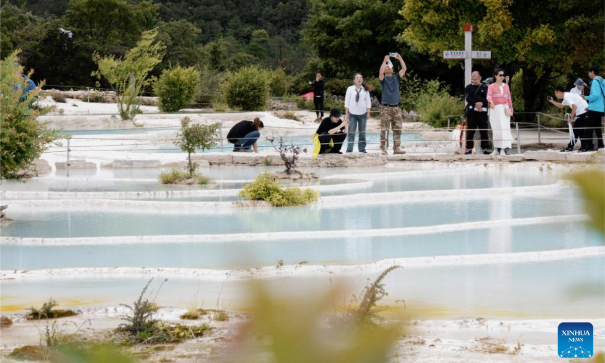 Tourist visit Baishuitai in Sanba Township, Shangri-la, the Deqen Tibetan Autonomous Prefecture, southwest China's Yunnan Province, June 26, 2025. Formed by the sediments of high calcium carbonate in spring waters, Baishuitai is one of the biggest limestone terraces in China. (Xinhua/Pu Chao)