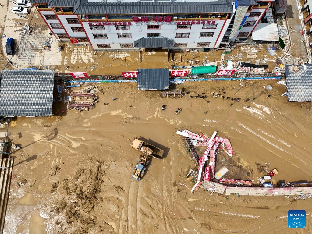 An aerial drone photo shows people clearing silt at a football field of the Cun Chao stadium in Rongjiang County, southwest China's Guizhou Province, June 25, 2025. Continuous heavy rainfall and upstream inflows have triggered severe flooding in two counties of Guizhou Province in southwest China, prompting mass evacuations. As of 2:30 p.m. Tuesday, 48,900 residents were temporarily evacuated in Rongjiang County and 32,000 in Congjiang County.The flood control emergency response has been escalated to Level I, the highest, in both counties. (Photo: Xinhua)