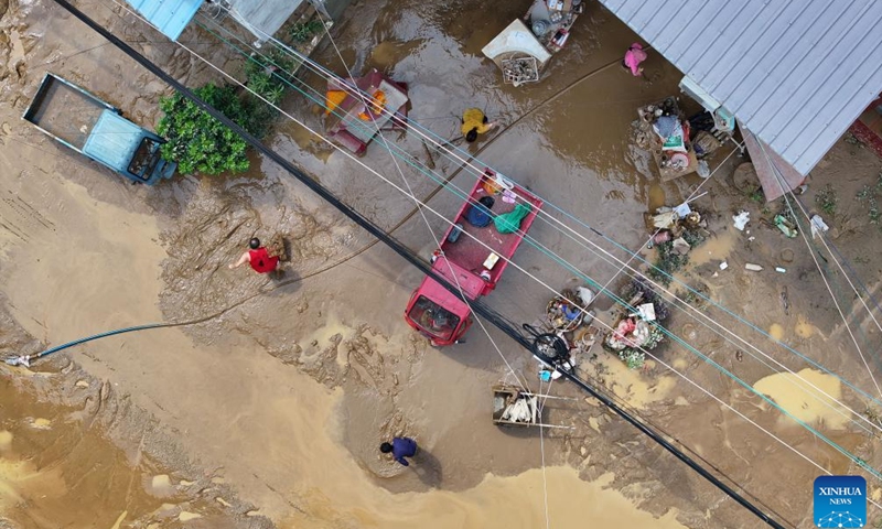 An aerial drone photo shows villagers clearing silt in Meilin Village, Meilin Township of Sanjiang Dong Autonomous County, south China's Guangxi Zhuang Autonomous Region, June 25, 2025. The local authorities beef up flood control and rescue efforts as days of torrential rains triggered flooding in several places in Guangxi. (Photo: Xinhua)