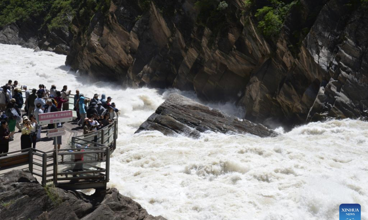 Tourists visit the Tiger Leaping Gorge scenic spot in southwest China's Yunnan Province, June 26, 2025. (Xinhua/Pu Chao)