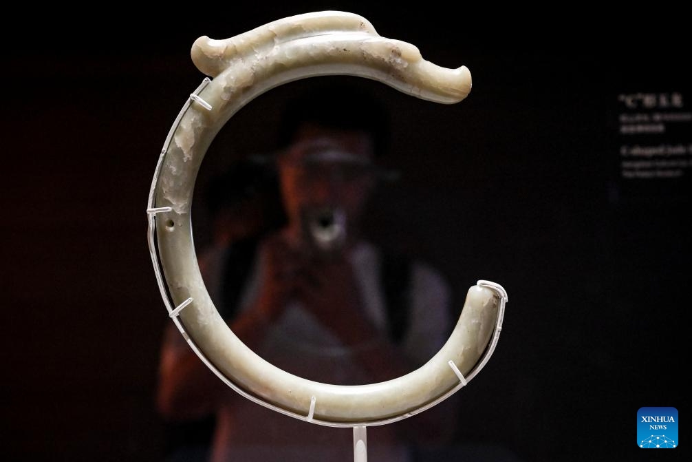 A visitor takes photos of an exhibit during a media preview of the exhibition titled Legends of Dragon: The Ancient Civilization of Hongshan Culture at the Shanghai Museum East in east China's Shanghai, June 25, 2025. The exhibition will open here on June 26. The exhibition is jointly organized by twenty domestic museums and archaeological institutions, showcasing over 300 cultural relics. Hongshan culture is an important prehistoric archaeological culture dating back roughly 5,000 to 6,000 years. (Photo: Xinhua)