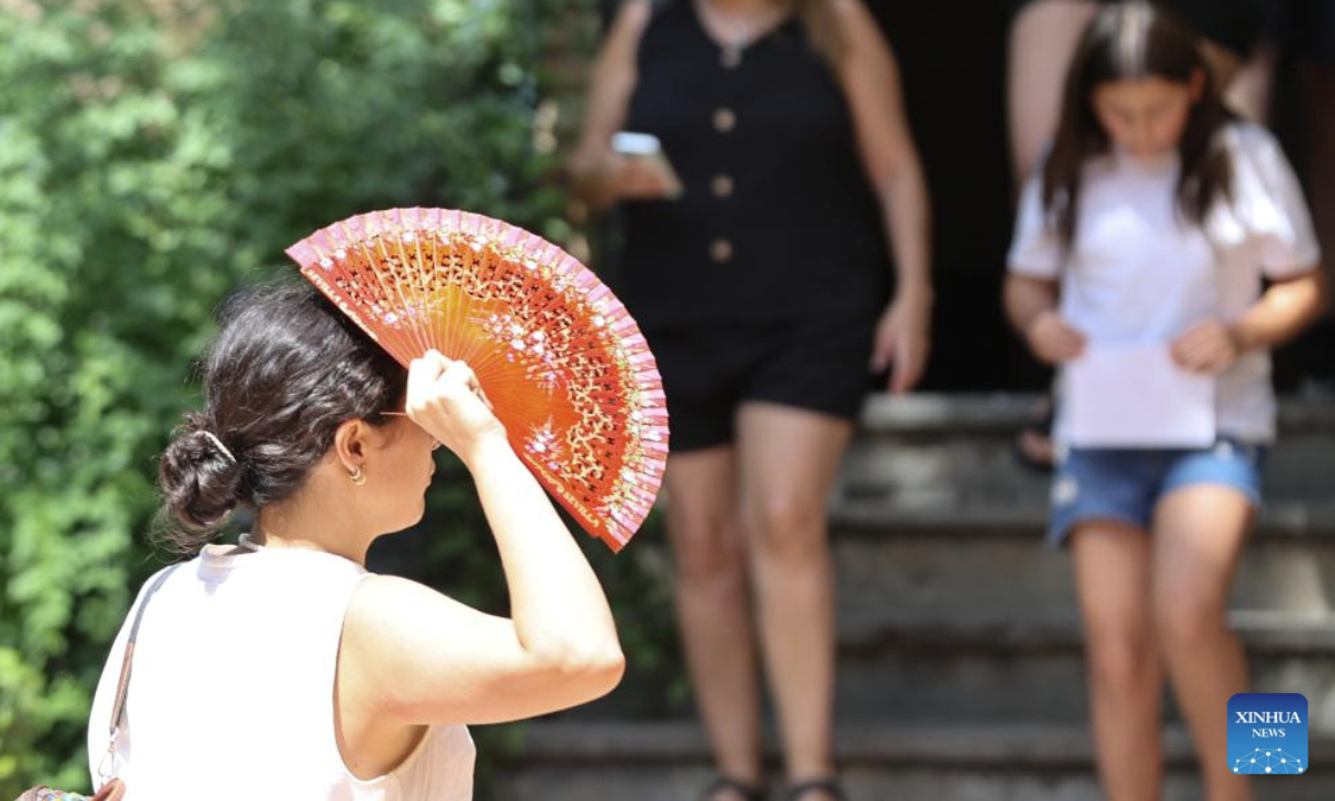 People walk amid the heatwave in Seville, Spain, July 2, 2025. Spain continues to endure a record-breaking heatwave. More than 100 monitoring stations of the Spanish meteorological agency AEMET registered temperatures exceeding 40 degrees Celsius during the first major heatwave of the year. (Xinhua/Li Jing)