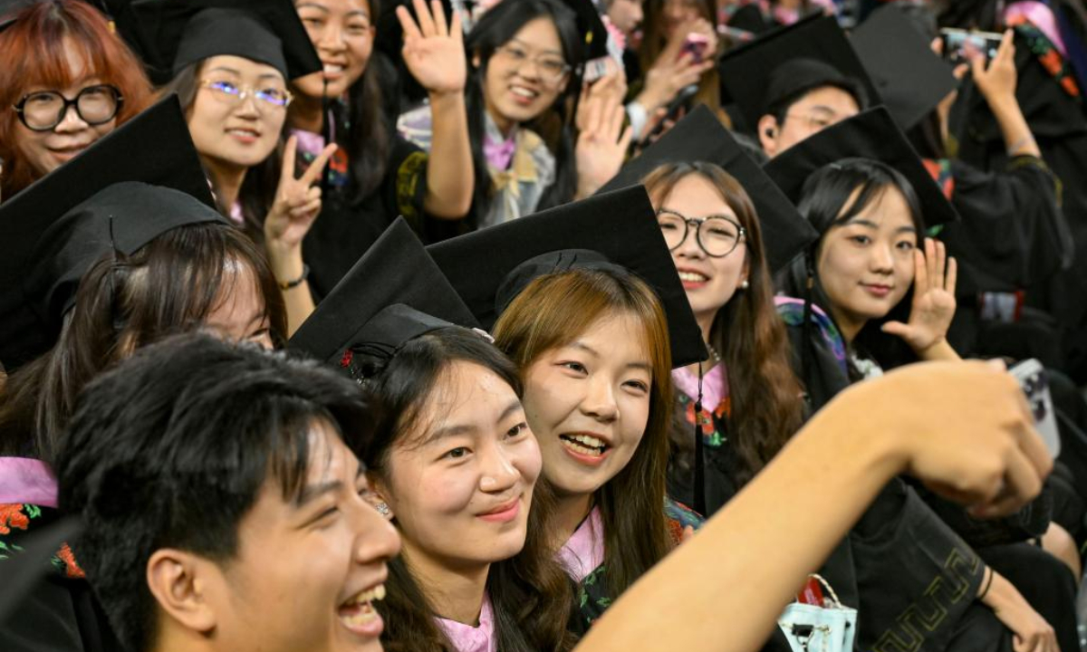 Graduates pose for a group photo after the graduation ceremony at Peking University in Beijing, capital of China, July 2, 2025. Peking University held the graduation ceremony on Wednesday and conferred bachelor's degrees to more than 4,000 graduates. (Xinhua/Chen Shuo)