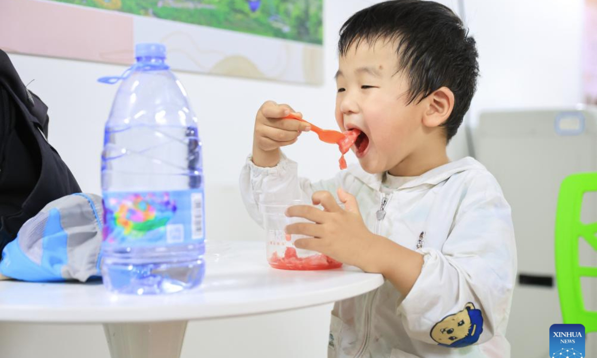 A child eats watermelon in an air-raid shelter in Nanjing, east China's Jiangsu Province, July 2, 2025. Due to hot weather this summer, Nanjing has opened 22 air-raid shelters for free, providing local residents with various social and leisure services. (Photo by Su Yang/Xinhua)