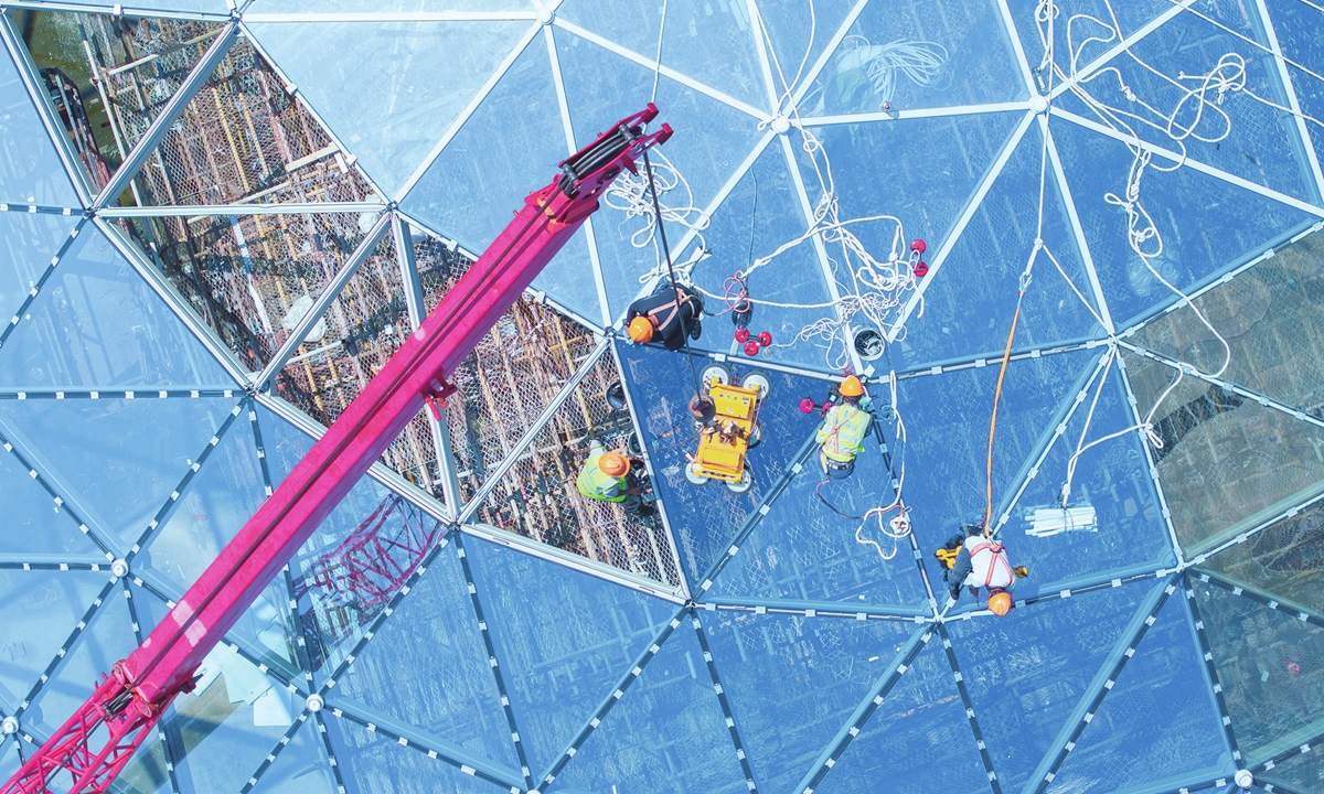 Workers assemble a glass screen ceiling at the construction site of a commercial compound in Nantong, East China's Jiangsu Province, on June 29, 2025. In the first five months of 2025, infrastructure investment in Jiangsu increased by 8.7 percent year-on-year, with investment for newly launched projects increasing 8.2 percent year-on-year, official data showed. Photo: VCG