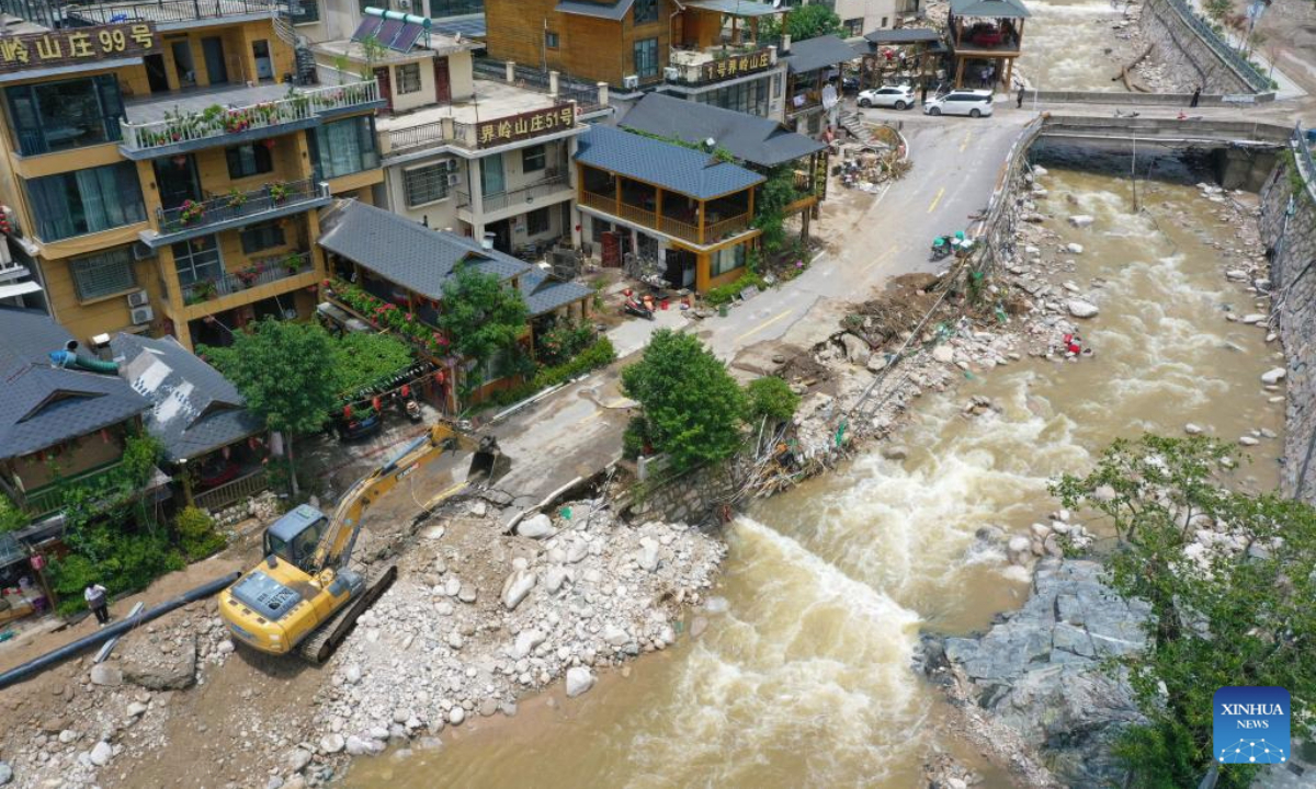 An aerial drone photo taken on July 2, 2025 shows an excavator clearing the road in Taiping Town of Xixia County, Nanyang City, central China's Henan Province. Torrential downpours in Taiping and Erlangping triggered a sudden surge in the water level in the downstream of a local river in Xixia County on Monday, damaging infrastructure and leaving some residents trapped.
Following the flooding, rescue efforts were immediately implemented, with two people successfully rescued. Further search and rescue efforts are underway in the quest to locate the three missing individuals. (Xinhua/Hao Yuan)