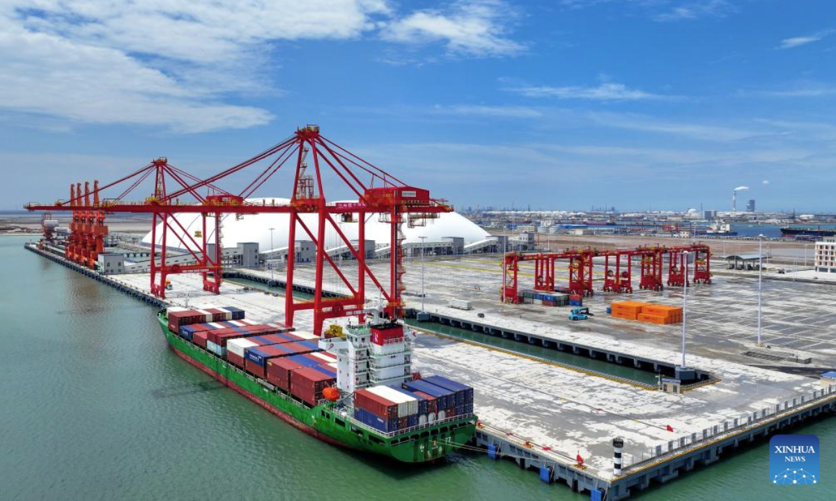 A drone photo shows a container ship berthing at the container terminal of a dike in Dongying Port, east China's Shandong Province, July 2, 2025. The first specialized container terminal of Dongying Port was put into use on Wednesday. (Xinhua/Zhu Zheng)