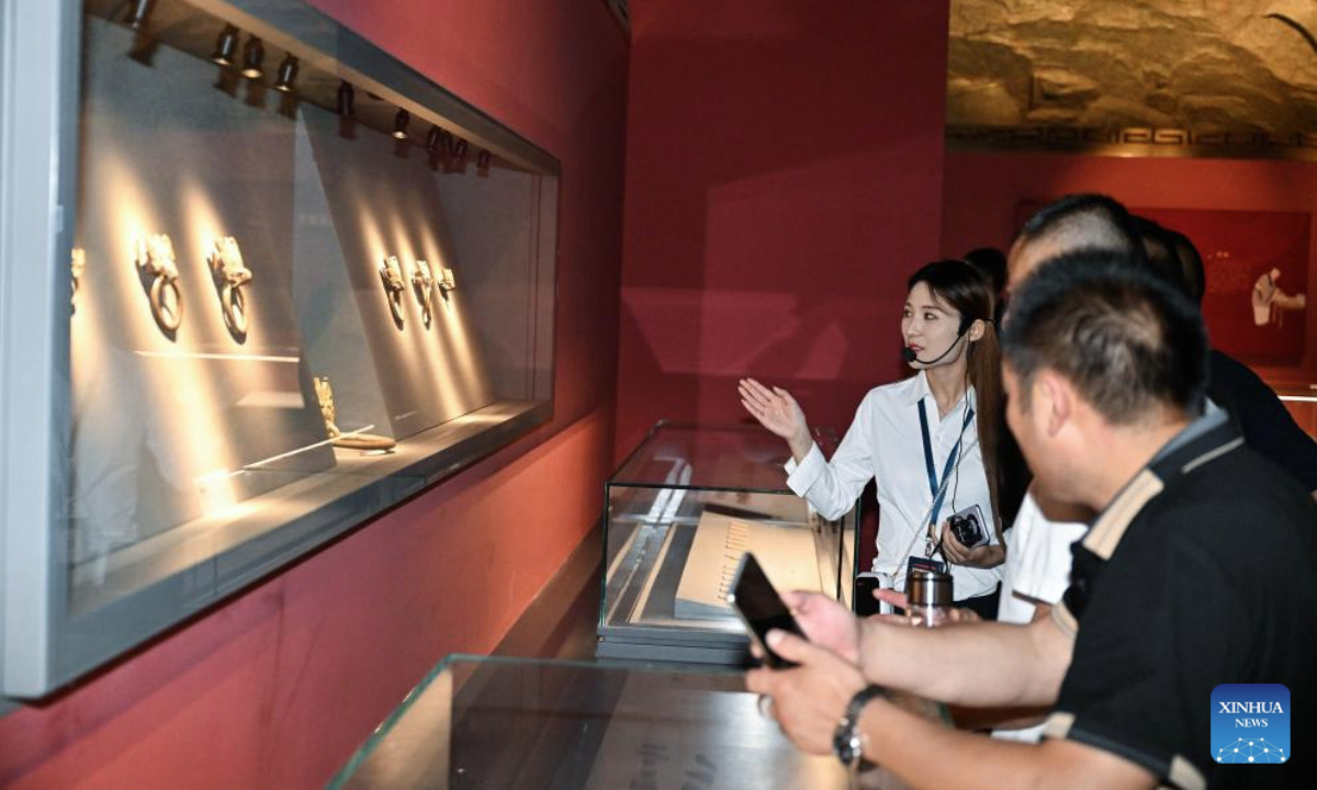 A tour guide introduces cultural relics to visitors at a museum featuring Han Dynasty (202 BC-220 AD) tombs in Xuyi, east China's Jiangsu Province, July 2, 2025. The museum of Han king's mausoleum at Dayun Mountain in Xuyi stages several featured exhibitions in this summer holiday to attract people to visit and learn about history knowledge. (Xinhua/Ji Chunpeng)