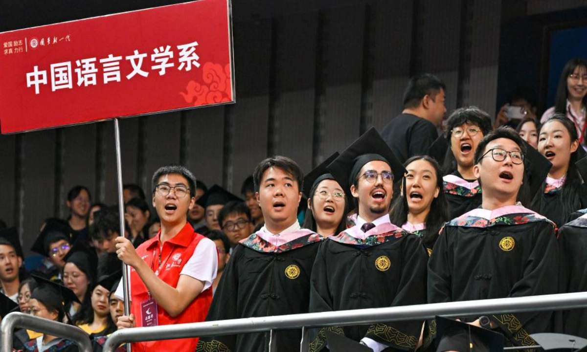 Graduates chant during the graduation ceremony at Peking University in Beijing, capital of China, July 2, 2025. Peking University held the graduation ceremony on Wednesday and conferred bachelor's degrees to more than 4,000 graduates. (Xinhua/Chen Shuo)

