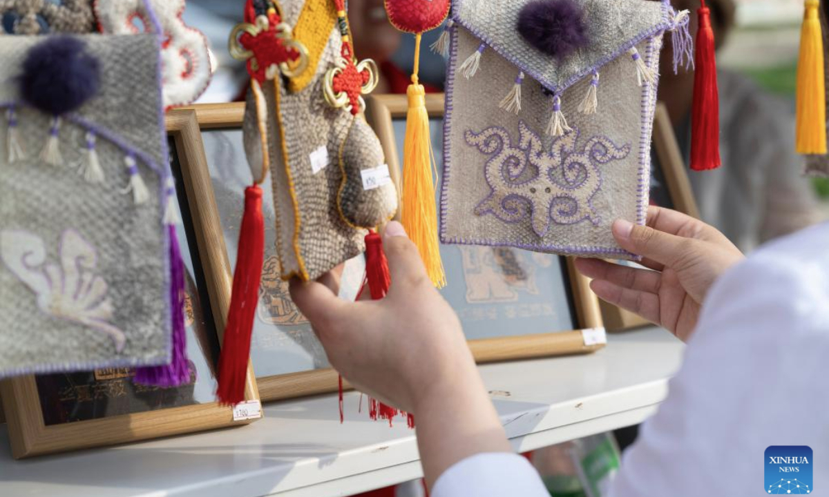 A visitor selects fish skin handicrafts during an event themed with Wurigong in the Hezhe ethnic village of Zhuaji in Wusu Town of Fuyuan City, northeast China's Heilongjiang Province, July 1, 2025. The Hezhe are one of the less populous ethnic groups in China, residing along the Heilongjiang, Songhuajiang and Wusuli rivers. Due to their location in the east, they are known as the sun watchers.

Wurigong means joy and celebration in the language of the Hezhe ethnic group. The event serves as a showcase of Hezhe culture, combining traditional music, dance, narrative art and sports. (Xinhua/Zhang Tao)