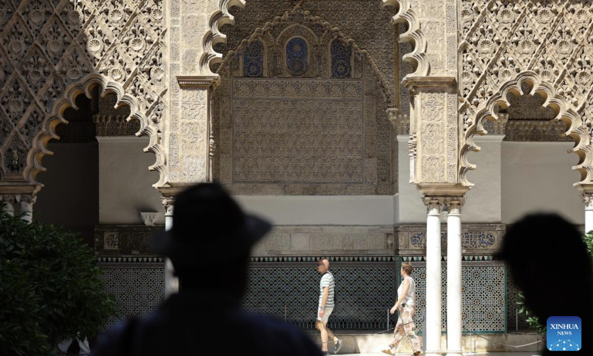 Tourists walk amid the heatwave in Seville, Spain, July 2, 2025. Spain continues to endure a record-breaking heatwave. More than 100 monitoring stations of the Spanish meteorological agency AEMET registered temperatures exceeding 40 degrees Celsius during the first major heatwave of the year. (Xinhua/Li Jing)

