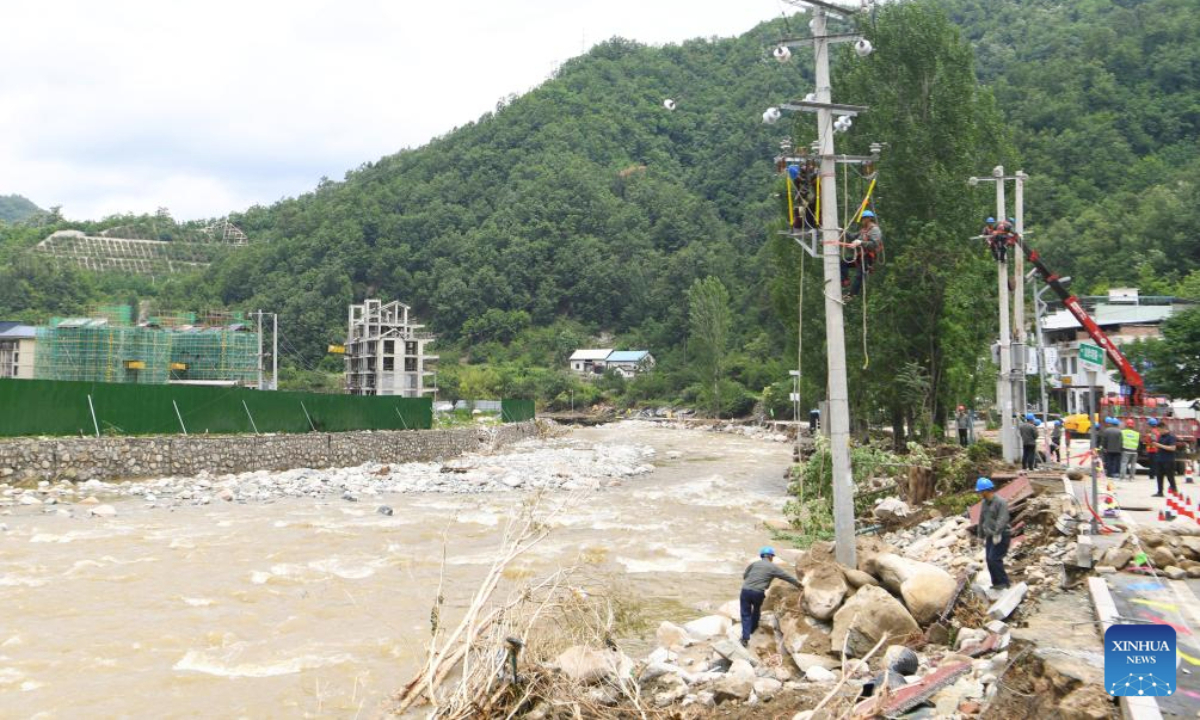 Staff members repair electric wires in Taiping Town of Xixia County, Nanyang City, central China's Henan Province, July 2, 2025. Torrential downpours in Taiping and Erlangping triggered a sudden surge in the water level in the downstream of a local river in Xixia County on Monday, damaging infrastructure and leaving some residents trapped.
Following the flooding, rescue efforts were immediately implemented, with two people successfully rescued. Further search and rescue efforts are underway in the quest to locate the three missing individuals. (Xinhua/Hao Yuan)