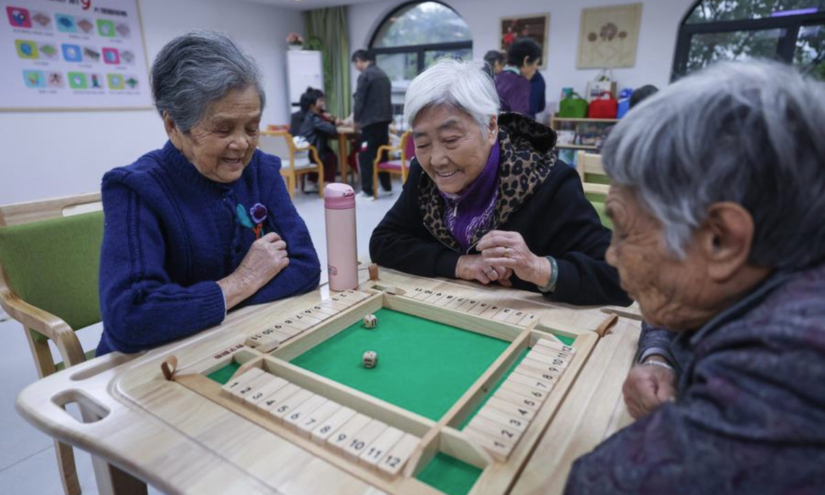 Senior citizens play wooden brain-training toys at an elderly care service center in Yunhe County of Lishui City, east China's Zhejiang Province, Nov. 10, 2023.  (Xinhua/Xu Yu)