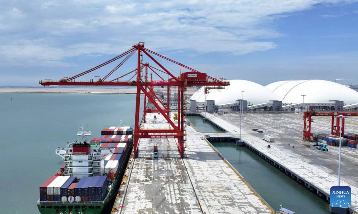 A drone photo shows a container ship berthing at the container terminal of a dike in Dongying Port, east China's Shandong Province, July 2, 2025. The first specialized container terminal of Dongying Port was put into use on Wednesday. (Xinhua/Zhu Zheng)