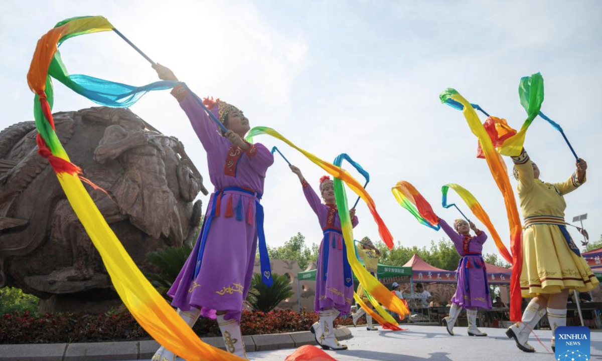 Dancers perform during an event themed with Wurigong in the Hezhe ethnic village of Zhuaji in Wusu Town of Fuyuan City, northeast China's Heilongjiang Province, July 1, 2025. The Hezhe are one of the less populous ethnic groups in China, residing along the Heilongjiang, Songhuajiang and Wusuli rivers. Due to their location in the east, they are known as the sun watchers.

Wurigong means joy and celebration in the language of the Hezhe ethnic group. The event serves as a showcase of Hezhe culture, combining traditional music, dance, narrative art and sports. (Xinhua/Zhang Tao)