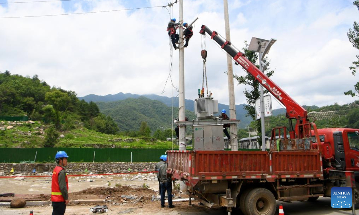 Staff members repair electric wires in Taiping Town of Xixia County, Nanyang City, central China's Henan Province, July 2, 2025. Torrential downpours in Taiping and Erlangping triggered a sudden surge in the water level in the downstream of a local river in Xixia County on Monday, damaging infrastructure and leaving some residents trapped.
Following the flooding, rescue efforts were immediately implemented, with two people successfully rescued. Further search and rescue efforts are underway in the quest to locate the three missing individuals. (Xinhua/Hao Yuan)