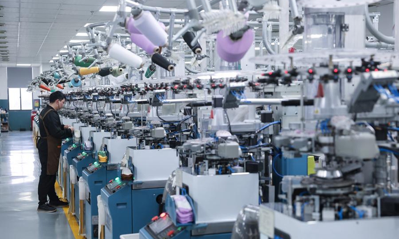 Intelligent machines produce socks in a workshop of a sock company in Zhuji, east China's Zhejiang Province, Feb. 24, 2024. (Photo: Xinhua)
