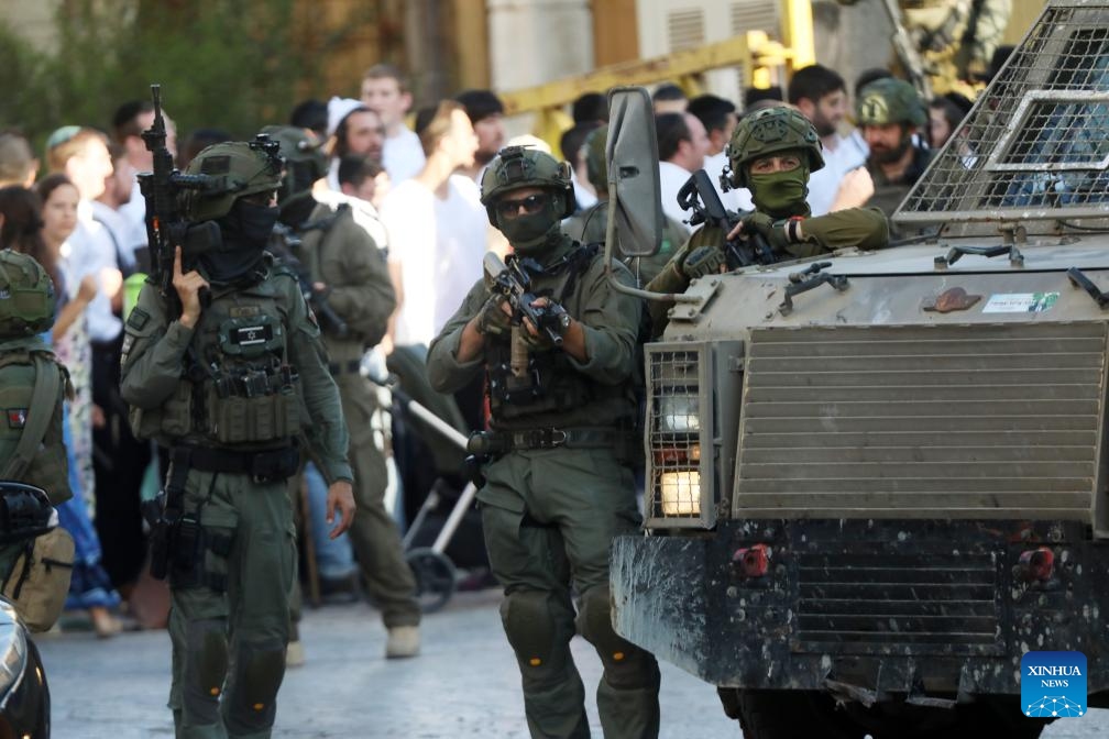 Members of Israeli forces secure the streets for Israeli settlers in the Old City of Hebron in the southern West Bank, on June 28, 2025. (Photo: Xinhua)