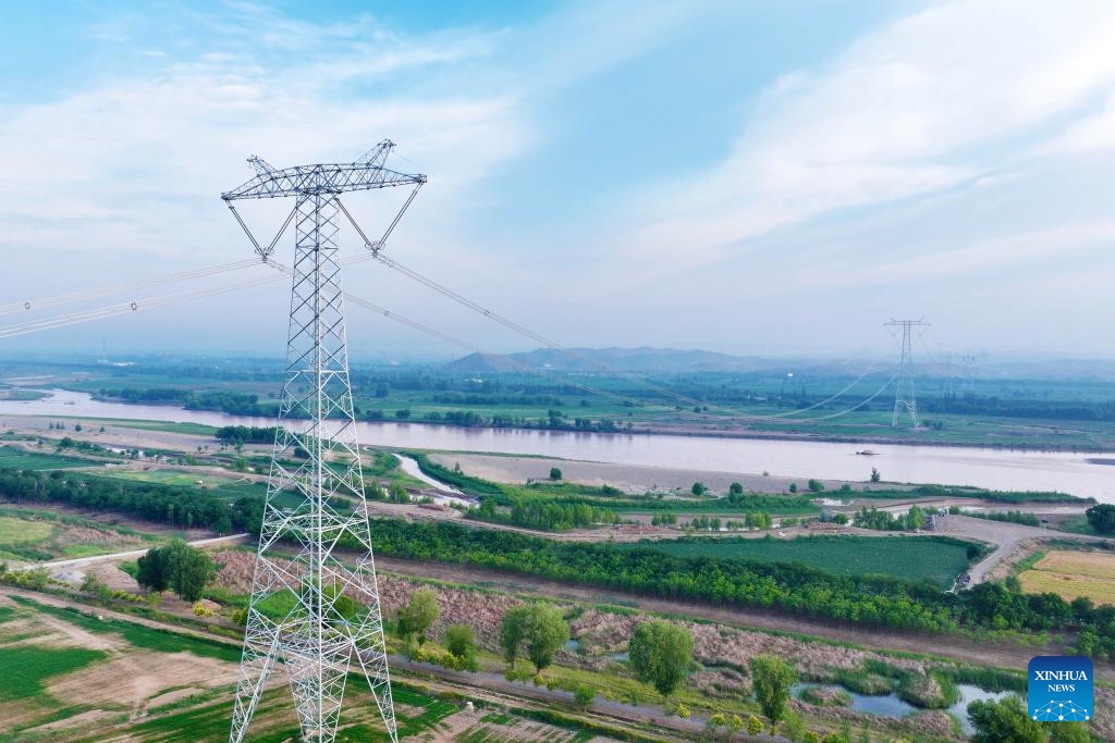 An aerial drone photo shows the cross-Yellow River section of the Ningxia-Hunan ±800 kV ultra-high voltage direct current transmission project in Zhongwei, northwest China's Ningxia Hui Autonomous Region, June 29, 2025. After a 168-hour trial, the ±800 kV ultra-high voltage direct current transmission project, which brings electricity from northwest China's Ningxia Hui Autonomous Region to central China's Hunan Province, kicked off its official operation at the capability of 4-million-kilowatt on Sunday. (Photo: Xinhua)