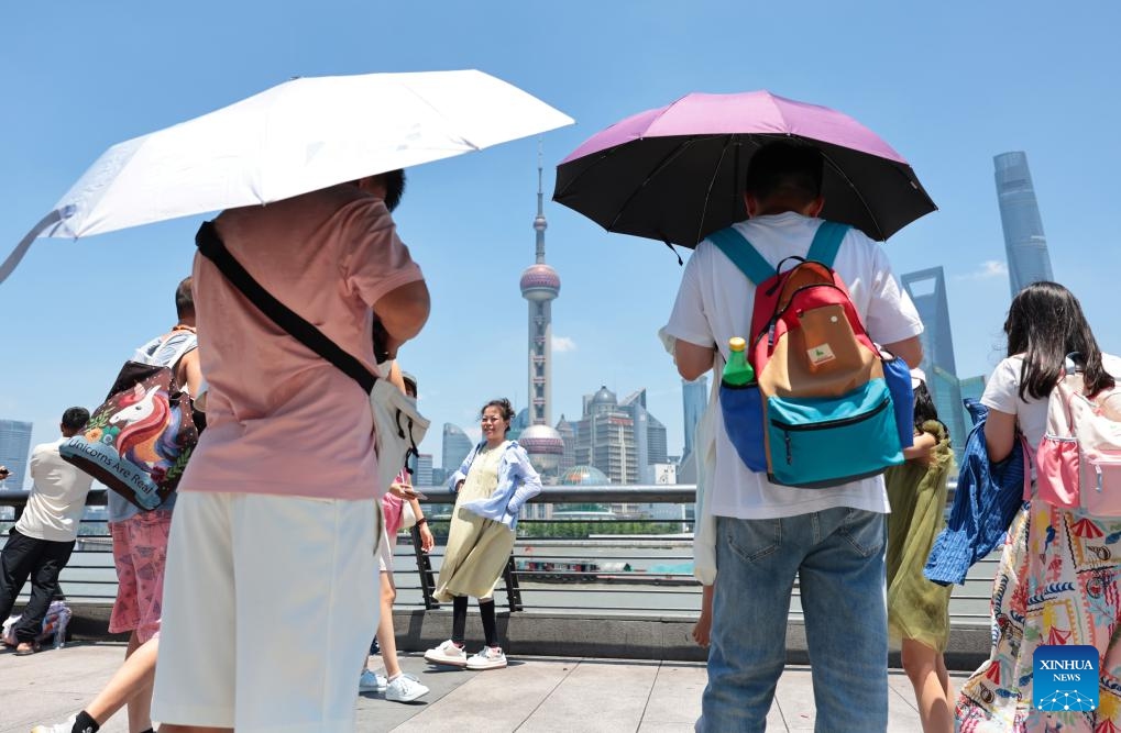 Tourists visit the Bund area in Shanghai, east China, June 29, 2025. Shanghai issued a heatwave alert on Sunday, which will last for about 10 days with high temperature hitting 39-40 degrees Celsius. (Photo: Xinhua)