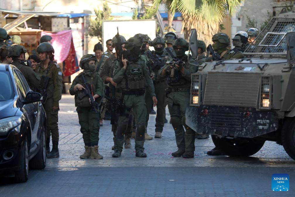 Members of Israeli forces secure the streets for Israeli settlers in the Old City of Hebron in the southern West Bank, on June 28, 2025. (Photo: Xinhua)
