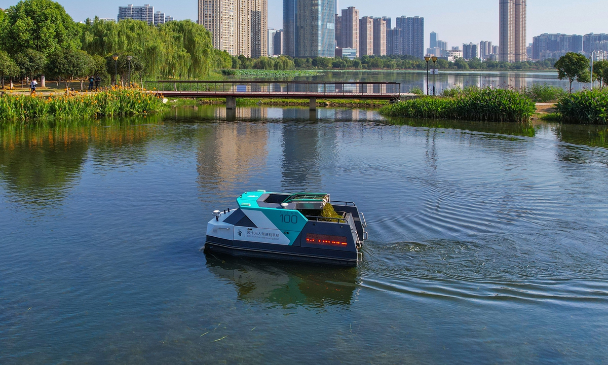 An unmanned grass cutter automatically trims water plants on the surface of a river in Wuhan, Central China's Hubei Province. Photo: VCG