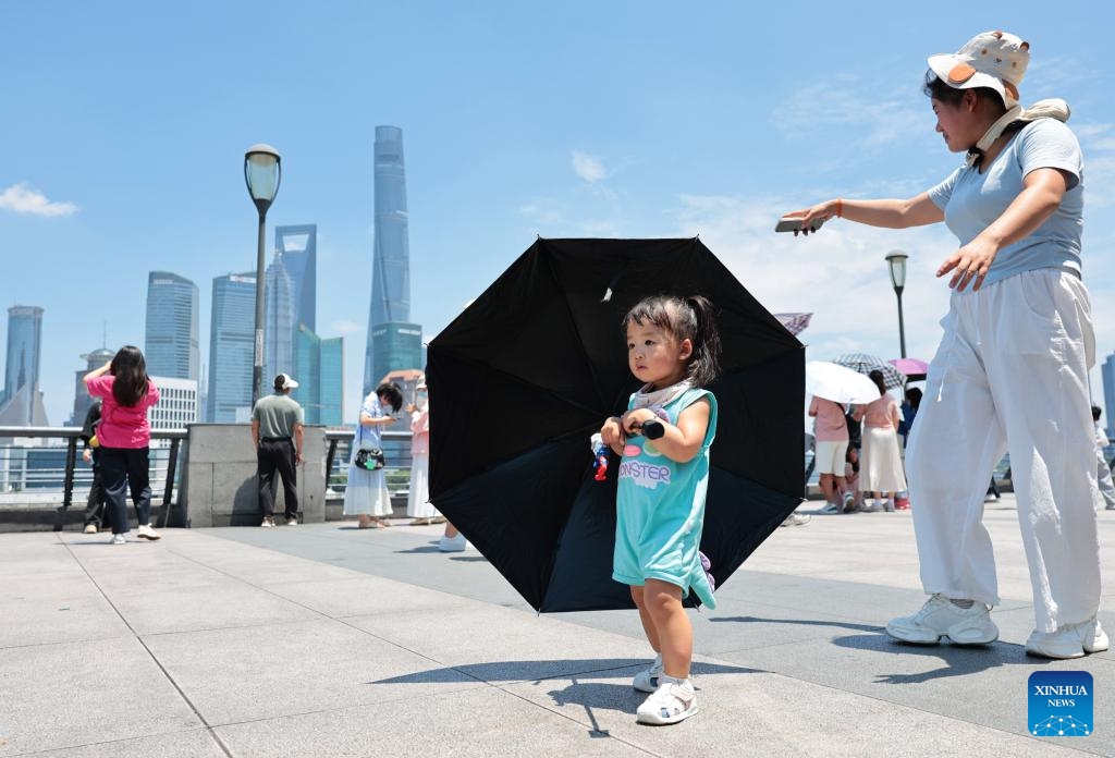 A girl walks at the Bund area in Shanghai, east China, June 29, 2025. Shanghai issued a heatwave alert on Sunday, which will last for about 10 days with high temperature hitting 39-40 degrees Celsius. (Photo: Xinhua)