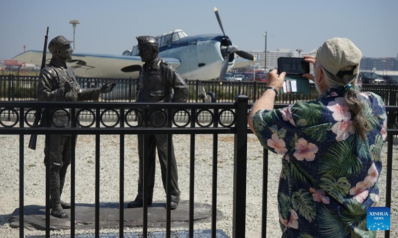 A man takes photos of the sculptures in Los Angeles, the United States, on June 28, 2025. A ceremony unveiling sculptures of Flying Tigers was held on Saturday to commemorate the 80th anniversary of the victory in the Chinese People's War of Resistance Against Japanese Aggression and the World Anti-Fascist War. (Photo: Xinhua)