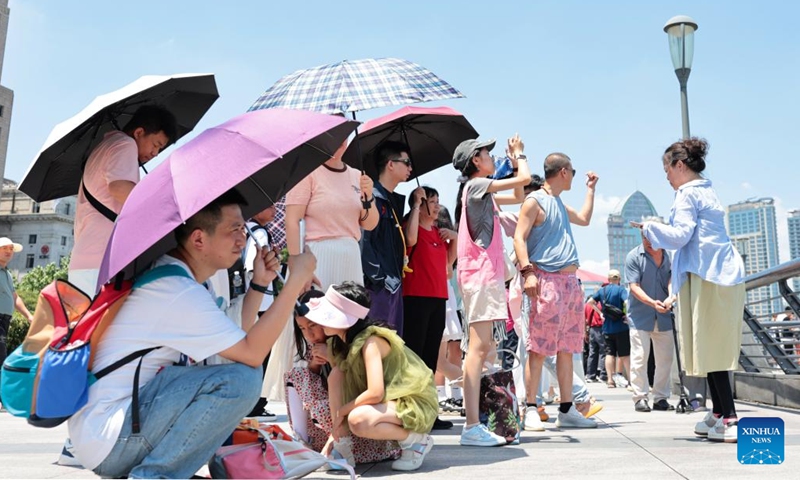 Tourists visit the Bund area in Shanghai, east China, June 29, 2025. Shanghai issued a heatwave alert on Sunday, which will last for about 10 days with high temperature hitting 39-40 degrees Celsius. (Photo: Xinhua)