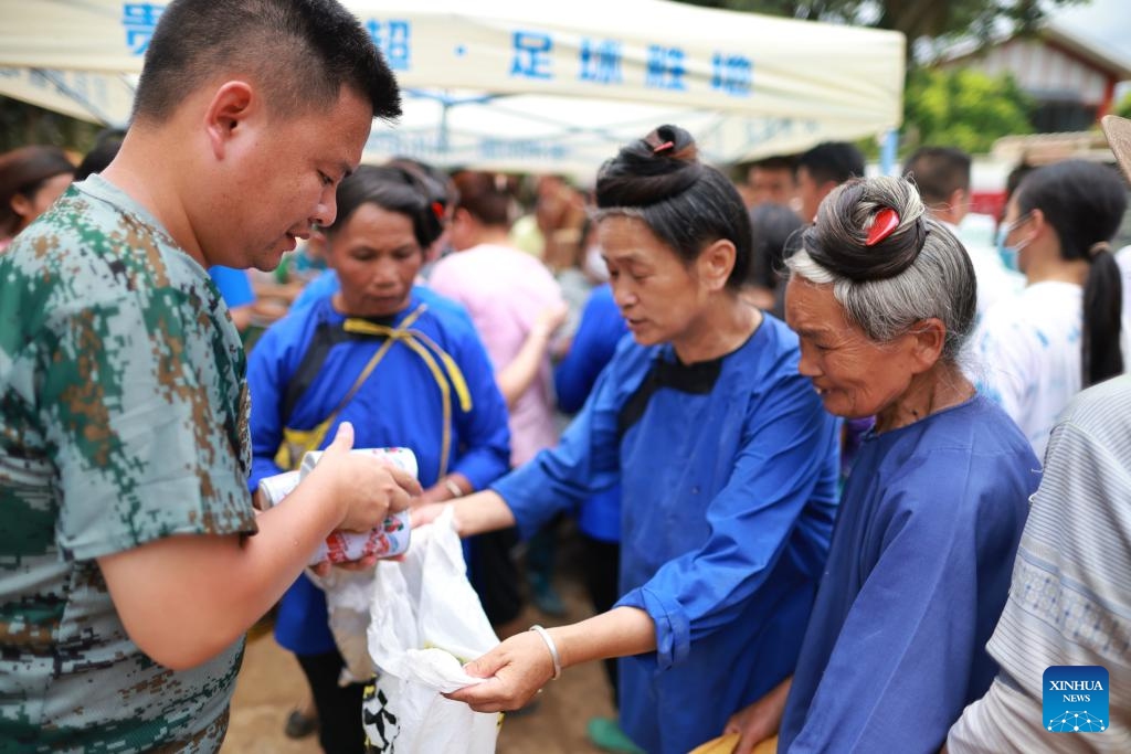 People receive emergency food aid in the flood-stricken Rongjiang County, southwest China's Guizhou Province, June 29, 2025. Heavy flooding has returned to Rongjiang County in southwest China's Guizhou Province, prompting local authorities to re-activate the highest-level emergency flood response, effective from 12:30 p.m. Saturday. Since flooding began, Rongjiang, with a population of 385,000, has received prompt rescue efforts from both authorities and volunteers. (Photo: Xinhua)