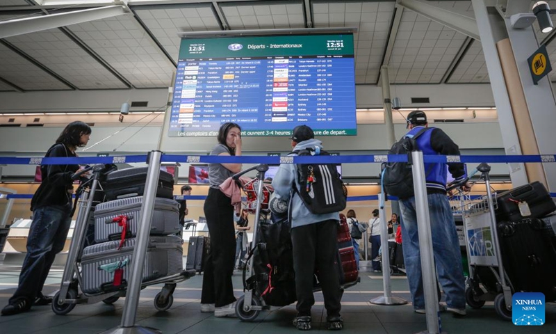 Passengers queue up to check in at Vancouver International Airport in Richmond, British Columbia, Canada, June 28, 2025. Vancouver International Airport is set for its busiest-ever summer, with over 6.7 million travelers expected from June 15 to September 2, the airport authority said. (Photo: Xinhua)