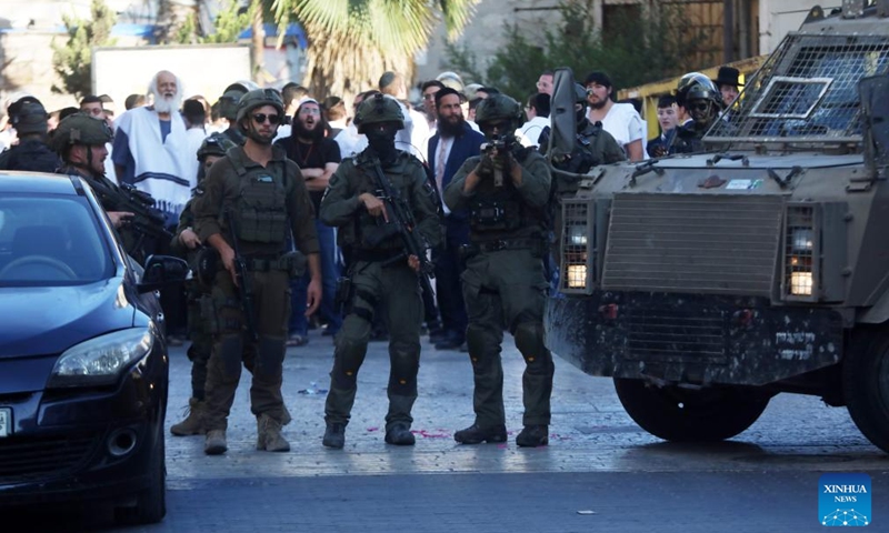 Members of Israeli forces secure the streets for Israeli settlers in the Old City of Hebron in the southern West Bank, on June 28, 2025. (Photo: Xinhua)