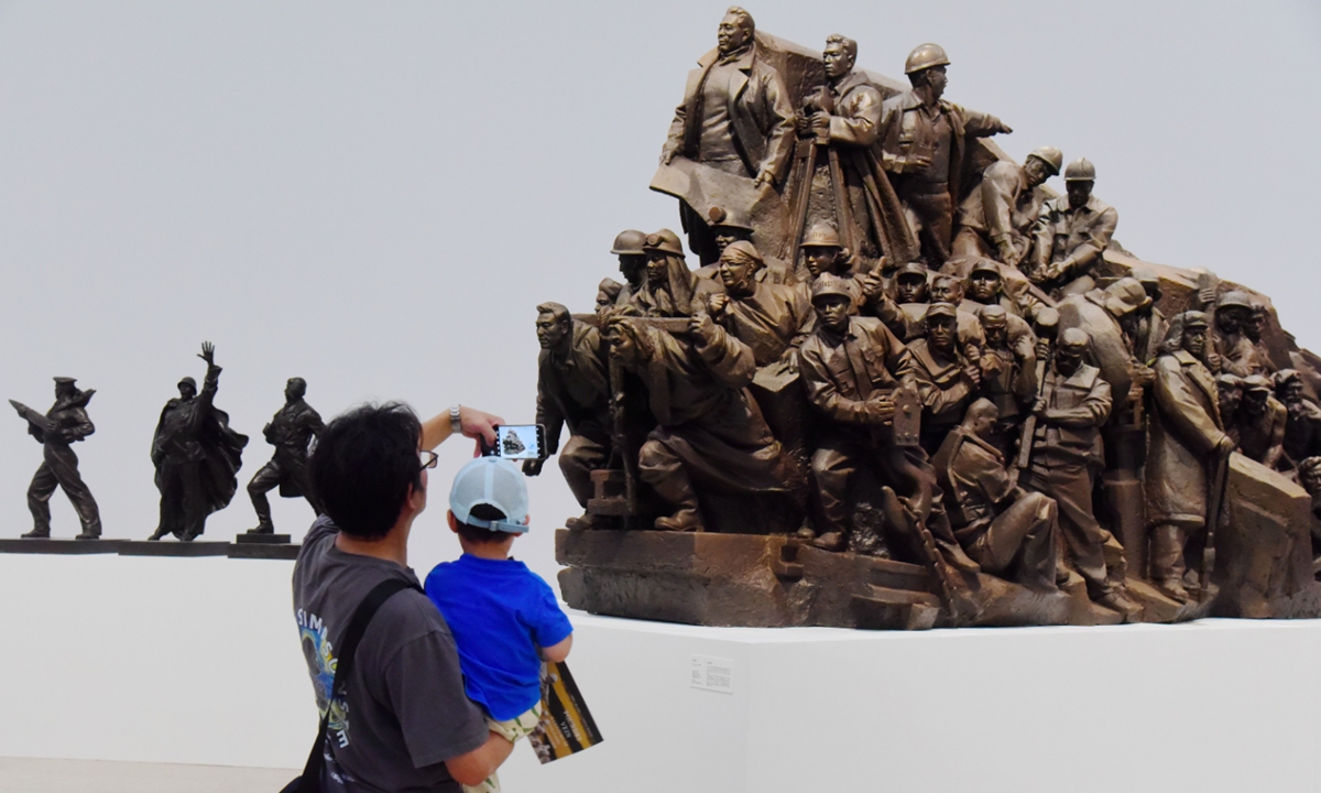 Visitors explore the Forging the Pulse: A Century of Sculpture in Zhejiang exhibition on July 2, 2025 in Hangzhou, East China's Zhejiang Province. The exhibition features 177 works by 90 artists, systematically tracing the century-long lineage of modern sculpture in Zhejiang. Photo: VCG