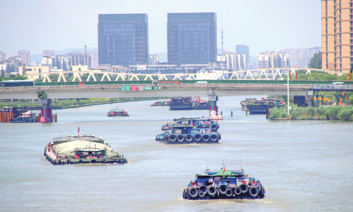 Cargo ships navigate the Suzhou section of the Beijing-Hangzhou Grand Canal in East China's Jiangsu Province on July 2, 2025, bustling with activities on this 
