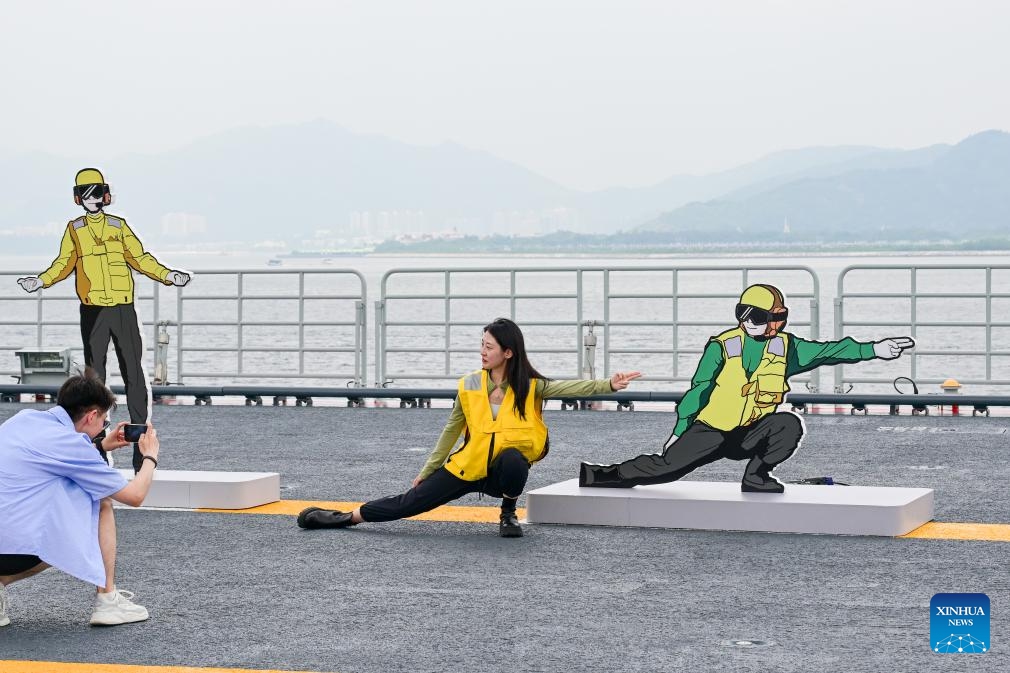 A visitor poses for a photo while visiting the aircraft carrier Shandong in Hong Kong, south China, July 5, 2025. Hong Kong celebrated the 28th anniversary of its return to the motherland with a significant visit from a fleet of the Chinese People's Liberation Army Navy, led by China's first homegrown aircraft carrier Shandong. (Photo: Xinhua)