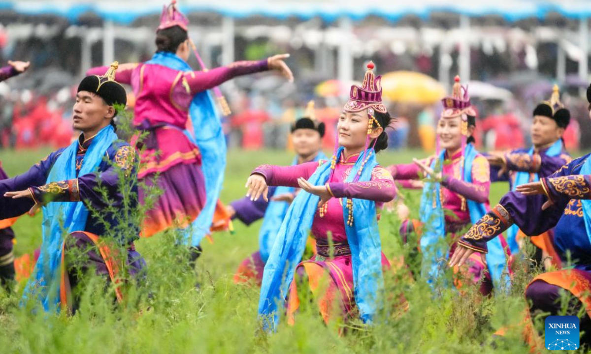 People perform during the opening ceremony of a Nadam fair held in Xilinhot, Xilin Gol League, north China's Inner Mongolia Autonomous Region, July 19, 2025. The Nadam Fair opened here on Saturday, featuring night parade performances, intangible cultural heritage handicraft making events, and ethnic game experiences. The fair has effectively invigorated the summer tourism market, and attracted tourists to experience the charm of grassland culture. (Xinhua/Ma Jinrui)