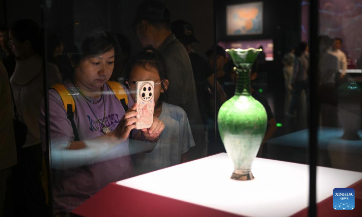 People take photos of exhibits at the Inner Mongolia Museum in Hohhot, north China's Inner Mongolia Autonomous Region, July 30, 2025. (Xinhua/Bei He)