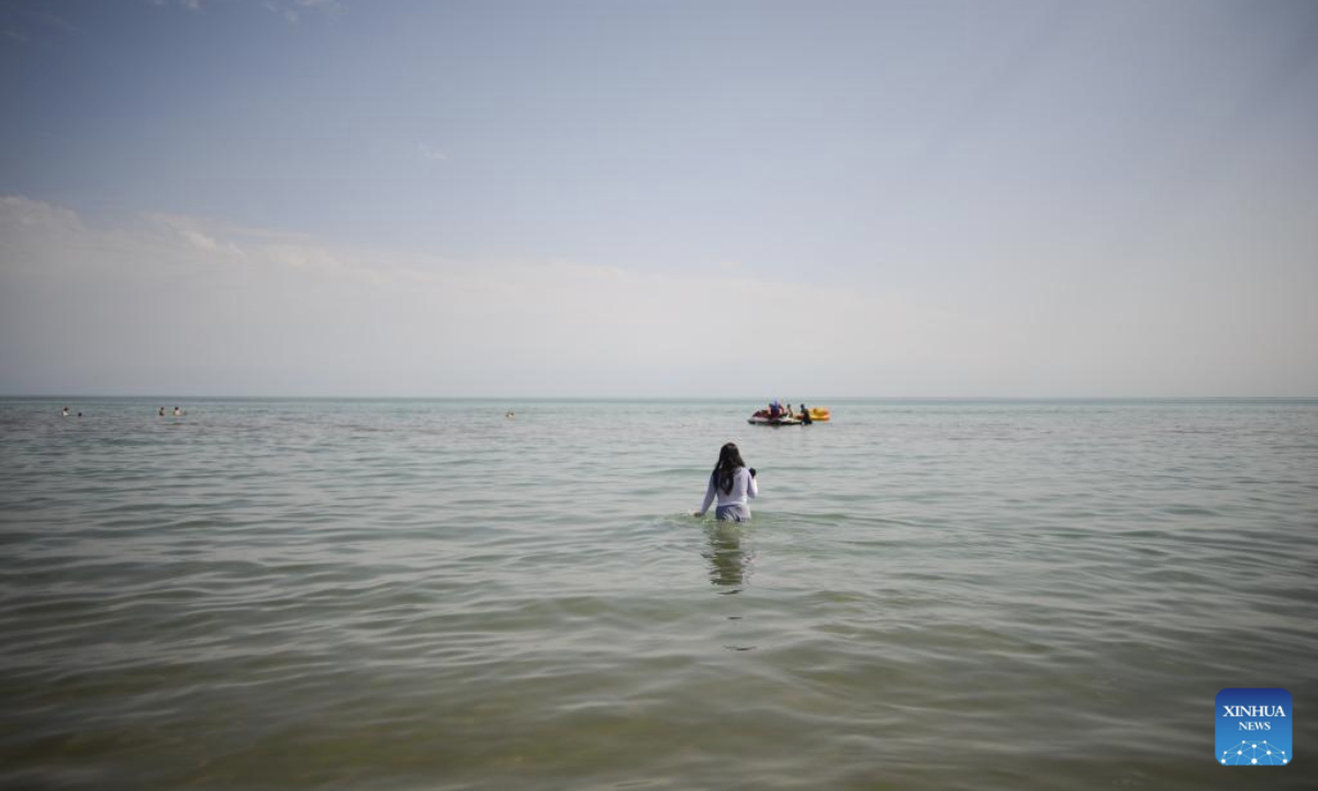 A woman cools herself off at the Kapchagay Reservoir in Konaev, Almaty region, Kazakhstan on July 26, 2025. Recently, the southern part of Kazakhstan, including the city of Almaty, Almaty region and South Kazakhstan region, has been hit by high heat waves. (Xinhua/Li Renzi)