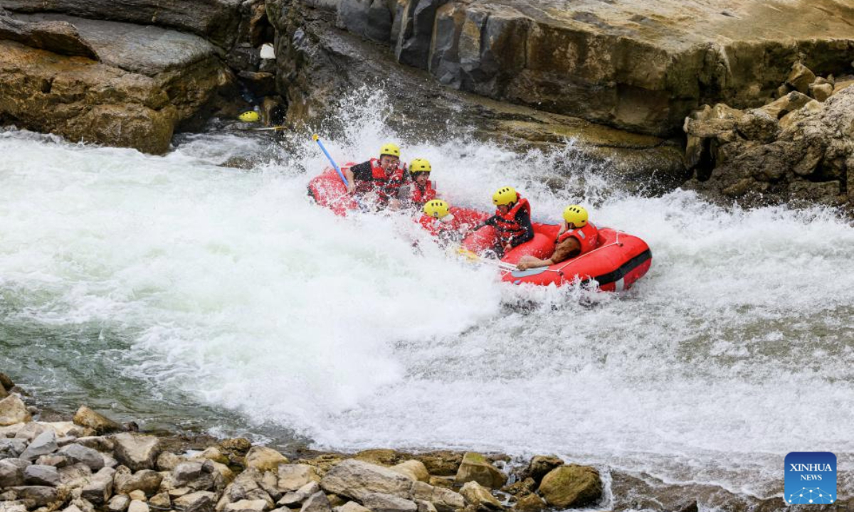 This photo taken on July 21, 2025 shows people rafting in an inflatable boat on Luobei River in Guiding County, southwest China's Guizhou Province. (Xinhua/Ou Dongqu)
