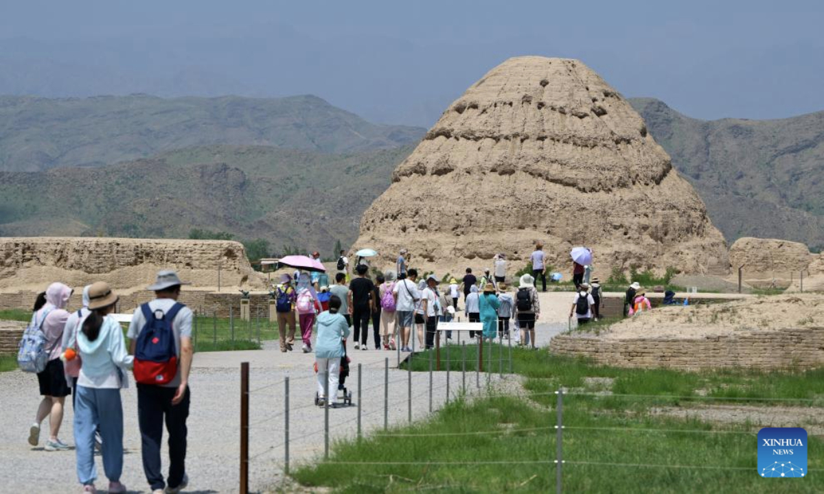 Tourists visit the Xixia Imperial Tombs archaeological site park in Yinchuan, northwest China's Ningxia Hui Autonomous Region, July 13, 2025. China's Xixia Imperial Tombs were officially added to the UNESCO World Heritage List on Friday during the 47th session of the World Heritage Committee held in Paris, France. (Photo by Yuan Hongyan/Xinhua)