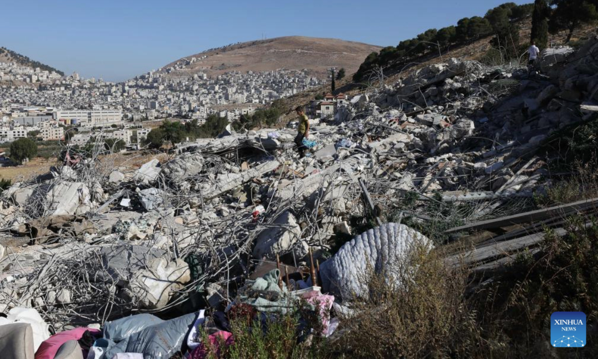 Palestinians inspect the rubble of a house demolished by an Israeli excavator, in the town of Rujeib, east of the West Bank city of Nablus, on July 9, 2025. (Photo by Nidal Eshtayeh/Xinhua)